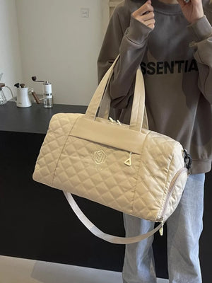 Diamond-stitched beige quilted duffel bag with adjustable strap and top handles