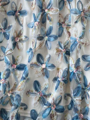 Layered skirt with embroidered blue floral pattern and sequins.