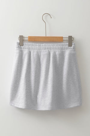 Light gray French terry drawstring skort with pockets and elastic waistband.
