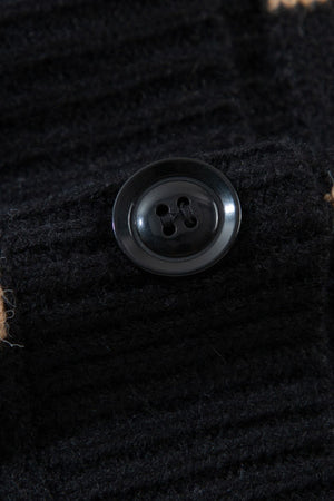 Black chunky knit button-down cardigan with a black button detail.