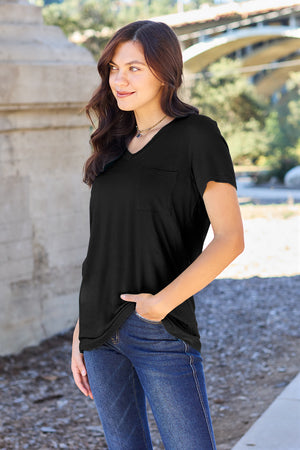 Black V-neck pocket tee with short sleeves and a relaxed fit, styled with jeans.
