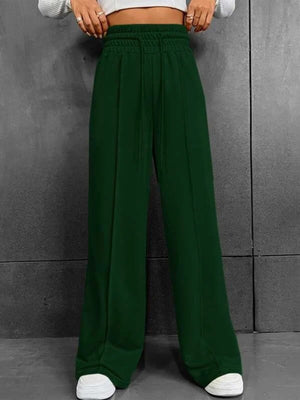 Dark green relaxed wide-leg sweatpants with drawstring waist and side seams.