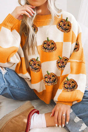 Checkerboard pumpkin appliqué knit sweater in tangerine and cream with sequin detail.