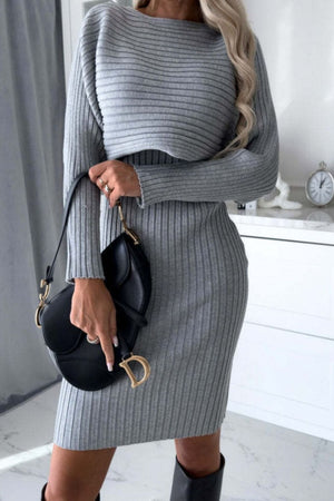 Grey ribbed knit midi dress with long sleeves and a boat neck, styled with a black saddle bag.