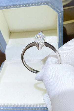 Sterling silver ring with a marquise cut solitaire diamond in a white gold setting.