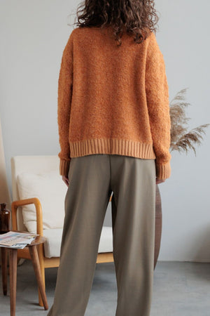 Textured bouclé collar cardigan in tangerine, 100% acrylic, with ribbed cuffs and hem.