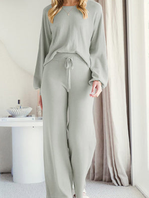 Light gray acrylic loungewear set with wide-leg pants and a crewneck sweater.