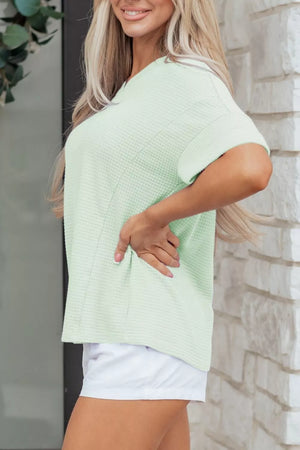 Light green waffle knit V-neck maternity t-shirt with short sleeves.
