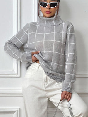 Gray grid-patterned turtleneck knit pullover sweater with long sleeves.