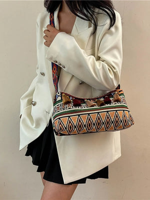 Geometric embroidered shoulder bag with tassels and colorful strap