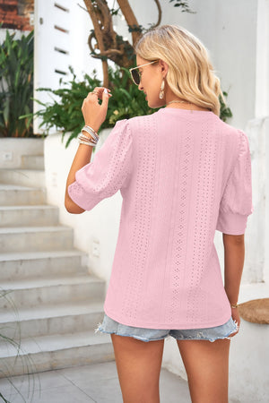 Blush pink eyelet detail puff sleeve blouse with a mock neckline.