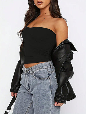 Black gathered bustier bandeau top with ruched detail, styled with jeans and a leather jacket.