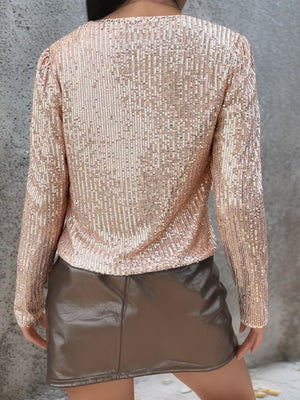 Rose gold sequin bolero jacket with long sleeves and a rounded neckline.