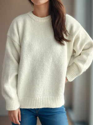 Oversized crewneck sweater in white textured knit with ribbed cuffs and hem.