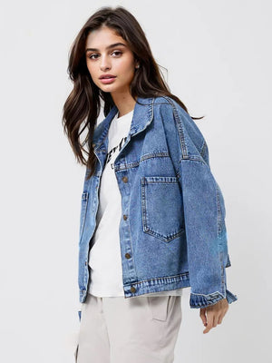 Denim trucker jacket in medium wash cotton with button front and chest pockets.