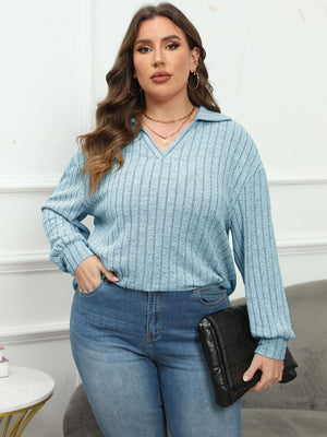 Relaxed ribbed polo top in pastel blue with a V-neck and long sleeves.