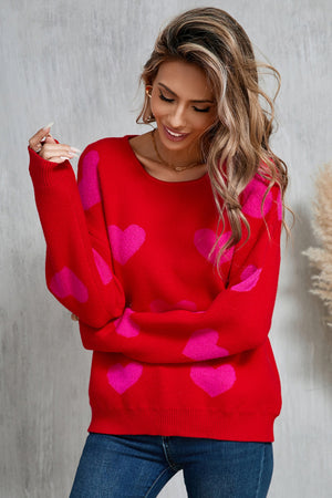 Red acrylic knit sweater with allover pink sweetheart intarsia pattern, crew neck.
