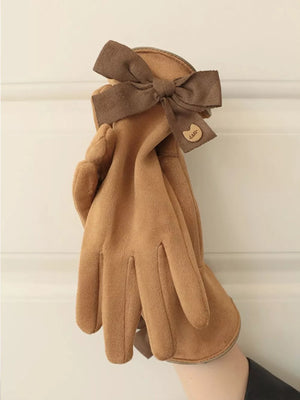 Camel gloves with a brown bow detail and charm