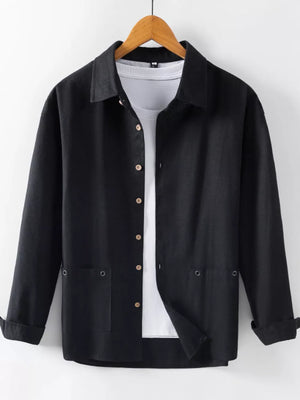 Black long sleeve button-up shirt with two chest pockets, worn over a white tee.