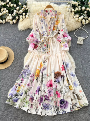 Vibrant floral midi dress with lantern sleeves, button front, and tie waist.