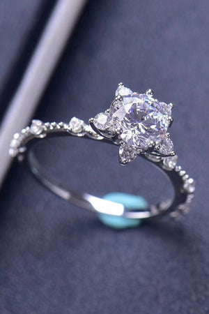 Silver halo ring with a large center diamond and smaller accent diamonds on the band.