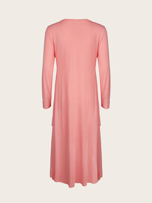 Pink midi dress with long sleeves and tiered hem detail.