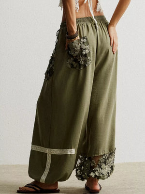 Moss drawstring harem pants with lace trim pockets and hem detail.