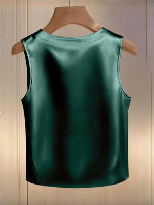 Green satin tank top with pearl embellishments, sleeveless, round neck.