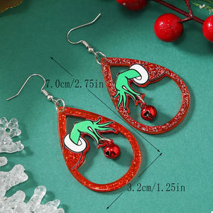 Acrylic teardrop earrings with Grinch hands and red bells, glitter red frames.