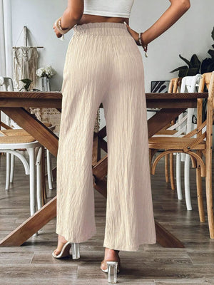 Textured gauze palazzo trousers in tan with wide legs and elastic waist.