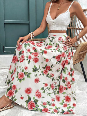 Elegant floral maxi skirt with red roses and green leaves on a white background, featuring pleats.