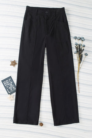 Black seamed front wide leg trousers with buttoned waist and pocket details.