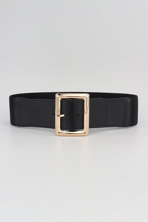 Black elastic belt with a wide gold-tone sculptural buckle.