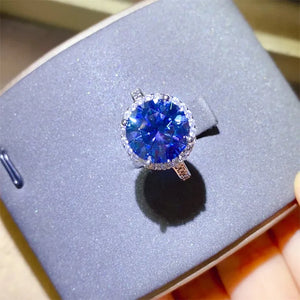 Silver halo cocktail ring with a large blue sapphire center stone.