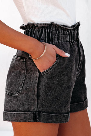 Dark washed denim paperbag cuff shorts with cuffed hems and front pockets.