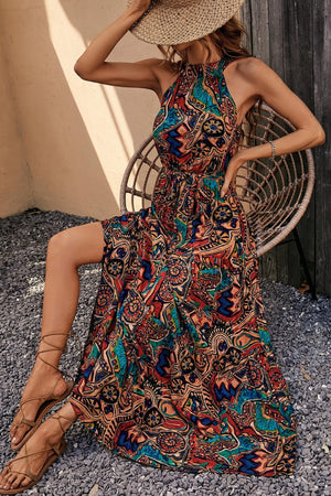 Halter neck maxi dress with paisley print in brown, green, blue, tan, and violet.