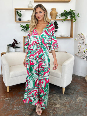 Green swirl print kimono sleeve jumpsuit with a V-neck and wide legs.