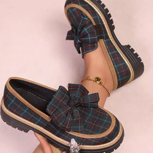 Plaid chunky loafers with bow accent and tan trim, featuring a lug sole.