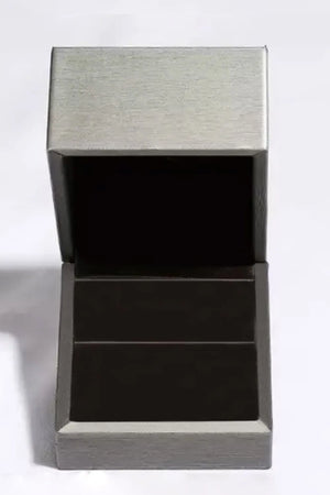 Silver ring box with open lid and dark interior