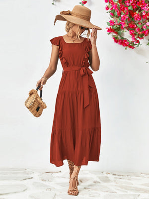 Tiered midi dress in brick red with flutter sleeves, square neck, and belted waist.