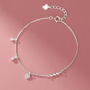 Silver sterling bracelet with delicate chain, pavé heart charm, and sparkling cubic zirconia accents.