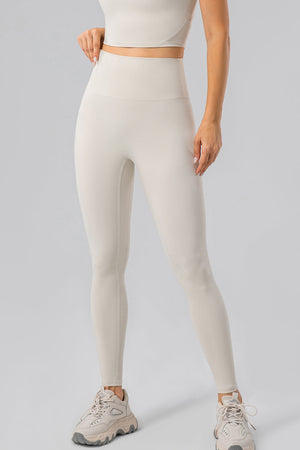Ivory high-waist performance leggings with a sculpted contour fit and seamless detailing.