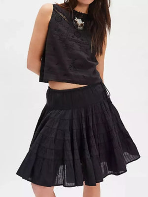 Tiered drawstring mini skirt in black with a ruffled hem and adjustable side tie.