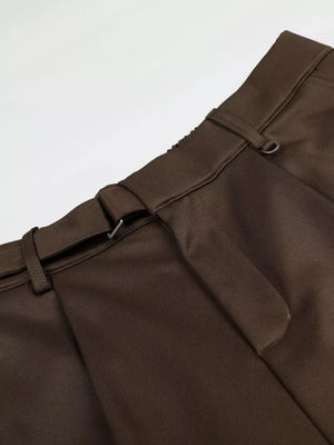 Brown pleated wide-leg capris with buckle detail and elastic waistband.