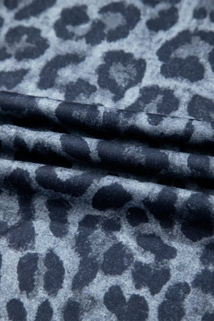 Maternity pants in dark navy with a grey leopard print and ruffled detail.