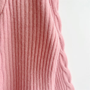 Dusty pink cable knit zip-neck sweater with ribbed texture and cable detail.