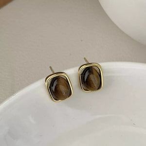 Gold color square stud earrings with polished tiger eye stones