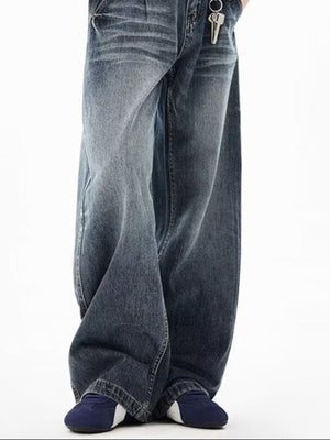 Men's blue wide-leg jeans with button closure and belt loops, styled casually.