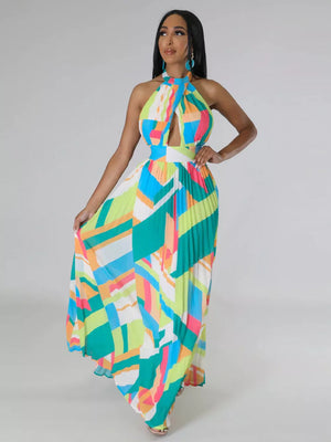 Halter neck maxi dress with geometric print, cutout, and pleated skirt.