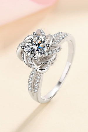 Silver floral halo ring with moissanite and pave accent stones.